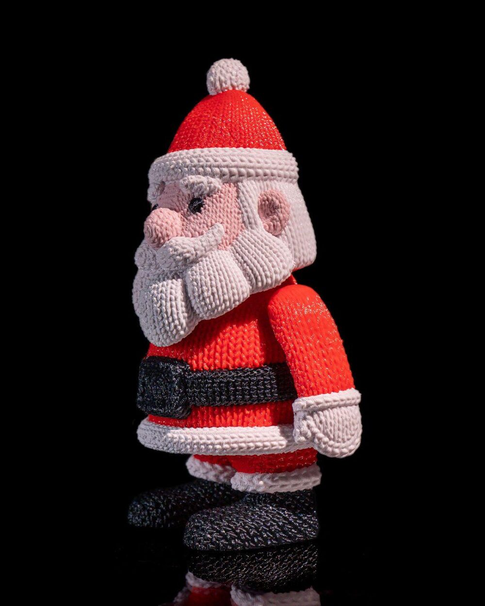 Knitted Santa Claus figure with red and white outfit, black belt and boots, displayed on a product page for festive Christmas decor.