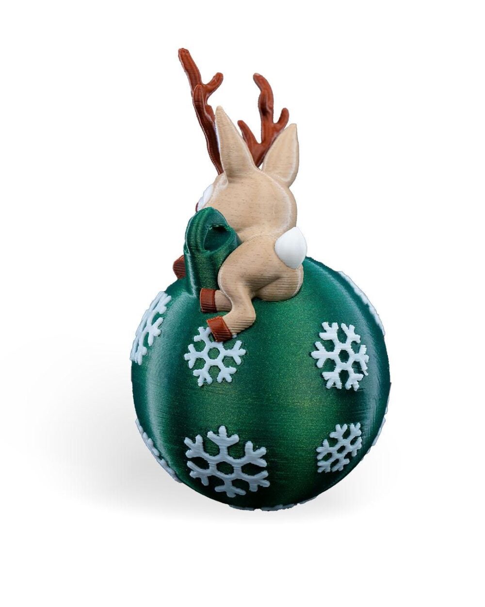 Handmade Lying Reindeer Christmas Ornament featuring a reindeer on a green ball adorned with white snowflakes. Unique holiday decoration.