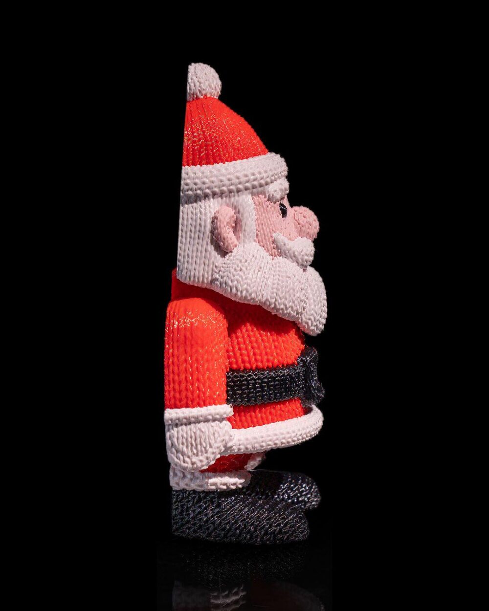 Santa Claus figure in red suit with white trim, black belt, and hat. Festive Christmas decor, holiday gift, collectible ornament.