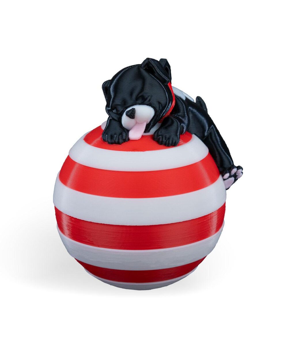 Handcrafted sleeping dog Christmas ornament on a red and white striped ball, perfect for festive holiday decor.