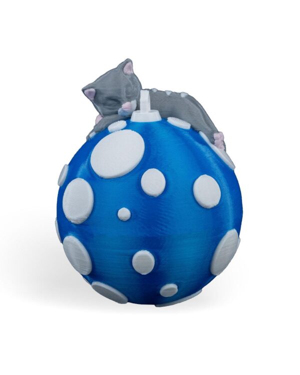 Handcrafted Sleeping Cat Christmas Ornament featuring a gray cat atop a blue ball with white polka dots; unique feline holiday decor.